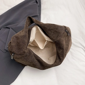 Brown corduroy tote bag with large capacity interior and zipper closure for daily commute