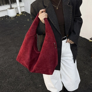 Deep red corduroy hobo tote bag with metal zipper detail for casual autumn commute