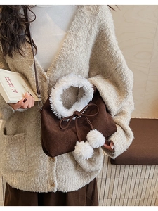 Detail of plush crossbody bag with white faux fur trim and cute decorative pom-poms