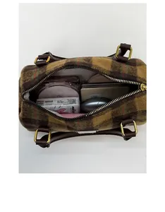 Vertical view of a plaid wool Boston bag showing internal storage for daily essentials