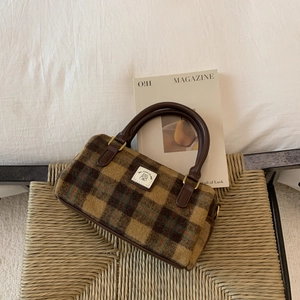 Retro brown plaid wool Boston bag with leather handles shown in a lifestyle setting
