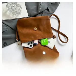Brown vintage faux leather bag showing spacious interior for phone and cosmetics