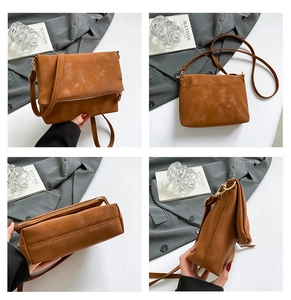 Detailed views of brown vintage frosted leather shoulder bag with metallic zipper and matte finish