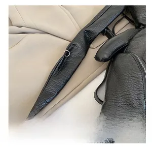 Detail of black lychee grain leather backpack with bunny ear design and silver zipper