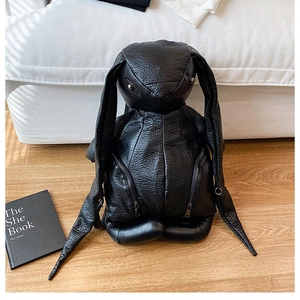 Detail of creative black rabbit backpack with long ears and lychee pattern PU leather finish