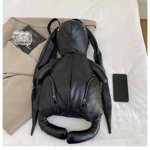 Detailed view of black lychee texture leather backpack in creative rabbit shape design
