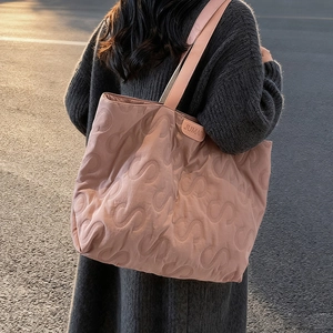 Detailed S-shaped quilted texture on soft pink lightweight commuter puffer tote bag