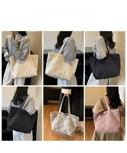 Quilted tote bag detail showing large capacity design in white, black, pink and grey colors