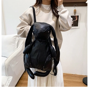Detailed view of unique rabbit-shaped black PU leather backpack with long ears and soft texture