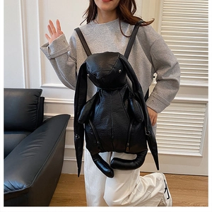 Detail of creative black rabbit backpack in lychee texture faux leather with zippers