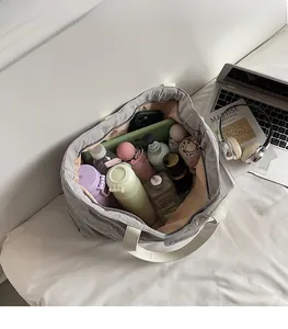 Top view of spacious grey quilted tote bag showing interior storage for laptop and essentials