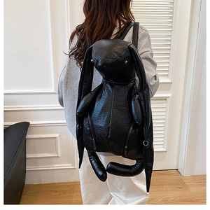 Detail of unique black rabbit backpack with long ears in pebbled vegan leather