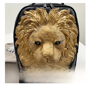 Close-up of a black leather backpack featuring a 3D golden lion head relief carving