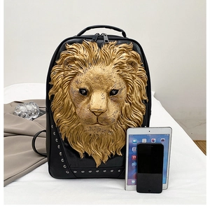Detail of black PU leather backpack with a 3D gold lion head relief and metal rivets