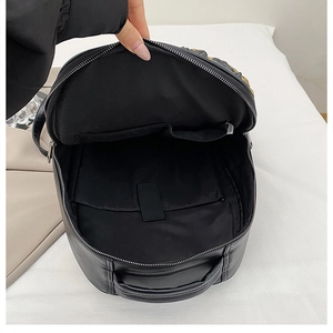 Black PU leather backpack interior with organized multi-pockets and secure compartments