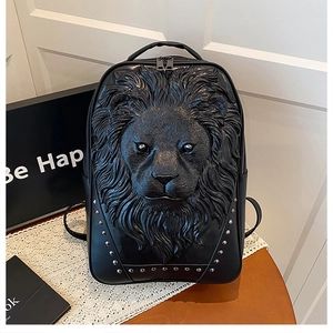 Detail of 3D lion head relief and silver studs on black leather commuter backpack