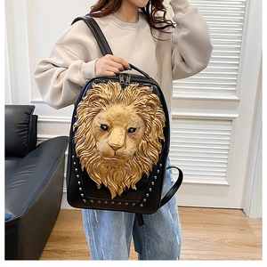 Close-up of black leather backpack featuring 3D gold lion head and silver stud details