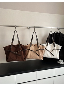 Tre borse tote in peluche di agnello nei colori marrone, beige e bianco su un rack