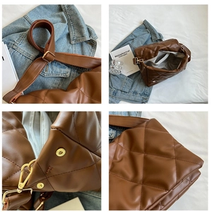 Brown quilted crossbody bag with large diamond stitching and golden hardware in lifestyle view