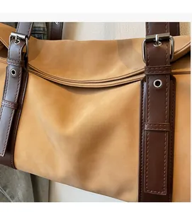 Detailed close-up of brown suede fabric with dark leather straps and silver buckle