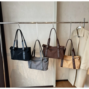 Showcasing four colors of minimalist tote bags with adjustable shoulder straps and soft textures