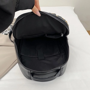 Black large capacity faux leather backpack with padded laptop compartment and interior pockets