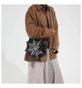 Detailed view of Gothic spider web shoulder bag with white embroidery on black leather