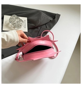 Top view of pink star-shaped bag interior with silver zipper and slim shoulder strap