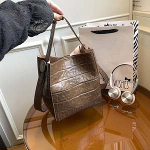 Dark brown crocodile pattern bucket bag with top handle and shoulder strap for daily commuting