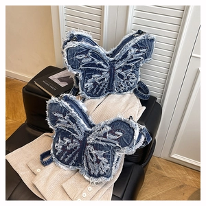 Detailed view of the butterfly-shaped denim shoulder bag with frayed edges and Y2K aesthetic