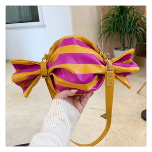 Detailed view of candy-shaped crossbody bag with yellow and purple stripes and silver hardware