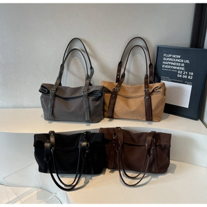 Detailed display of four neutral color tote bags featuring adjustable metal straps