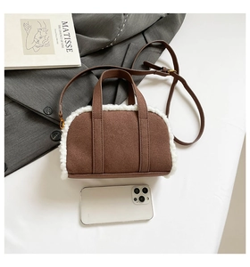 Brown faux suede bowling bag with white fleece trim shown with a phone for scale
