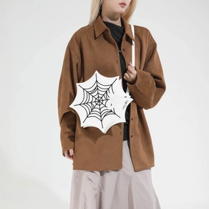 Unique white spider web shaped crossbody bag shown with model for a gothic fashion look