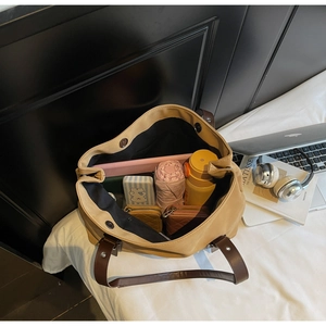 Top view of a large khaki tote bag showing spacious interior with laptop and daily items
