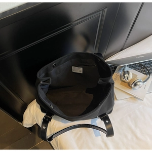 Top view of large black commuter tote bag showing spacious interior and magnetic closure