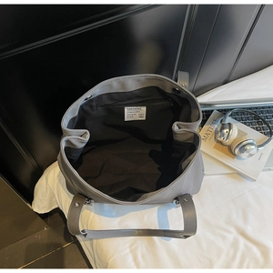 Top view of large gray tote bag showing spacious black interior and minimalist design