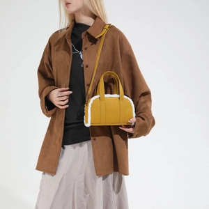 Chic yellow suede bowling bag with white fleece trim and adjustable shoulder strap