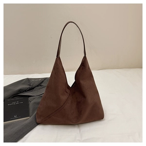 Detail of a dark coffee suede hobo bag with a minimalist triangular silhouette