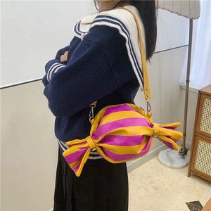 Niche candy-shaped crossbody bag with bold yellow and purple stripes and long strap