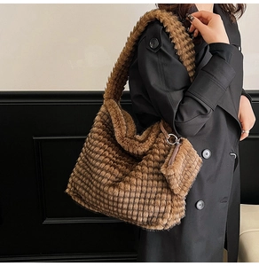 Detail of dark brown plush tote bag with textured grid pattern and mini pouch
