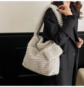 Detail of plush tote bag with horizontal stripe texture and small matching side pouch