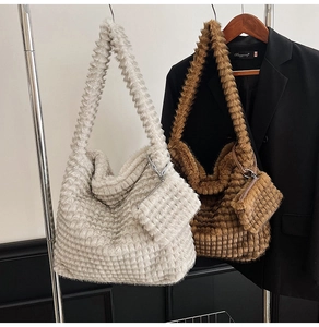Detail of faux fur tote bags in off-white and brown with soft ribbed velvet texture