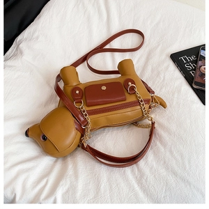 Detail of dachshund puppy crossbody bag featuring yellow and brown faux leather contrast