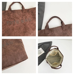 Close-up of the spacious interior compartment and rivet logo on dark brown tote bag