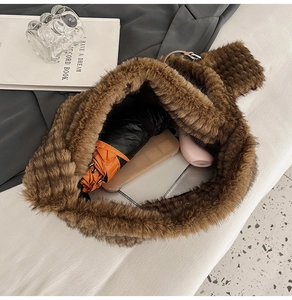 Top view of brown plush tote bag showing large capacity with umbrella and accessories