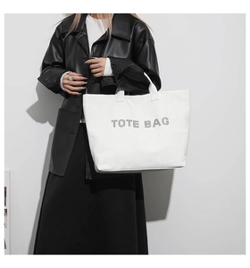 Fashionable white tote bag with letter print styling on high-quality model view