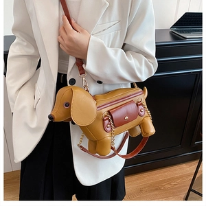 Detailed close-up of a creative dachshund-shaped PU leather crossbody bag with chain strap