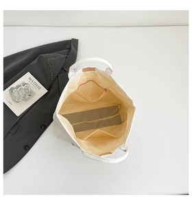 Interior view of large capacity white tote bag with zipper pocket and beige lining detail
