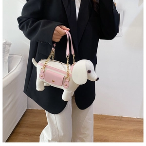 Detail of cute dachshund dog bag in white and pink faux leather with gold chain strap